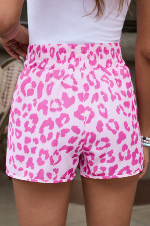 Pink leopard print shorts with elastic waistband and scalloped hem