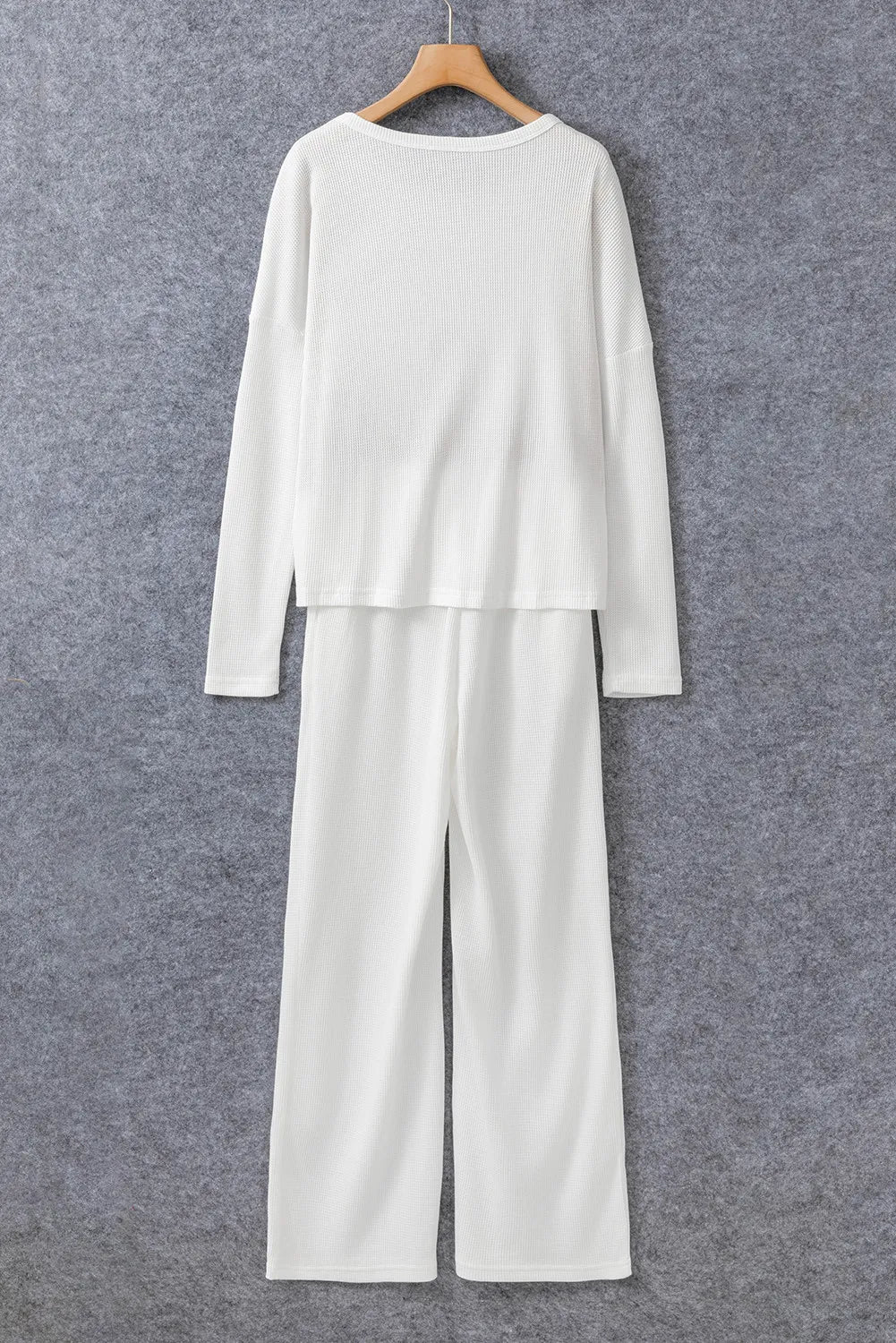 White ribbed loungewear set with crew neck long sleeve top and wide leg pants