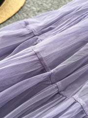 Elegant tiered tulle skirt in purple with gathered seams and a soft lining.