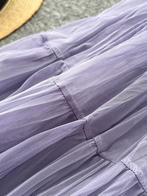 Elegant tiered tulle skirt in purple with gathered seams and a soft lining.