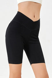 Black denim bermuda shorts with a crisscross waistband and a flattering fit.