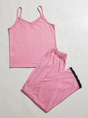 Pink cami lounge set with v-neck and lace trim on pants.