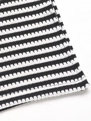 Black and white striped textured knit fabric detail of a halter top and slit skirt set.