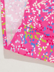 Hot pink blouse with abstract splatter print and mesh sleeves.