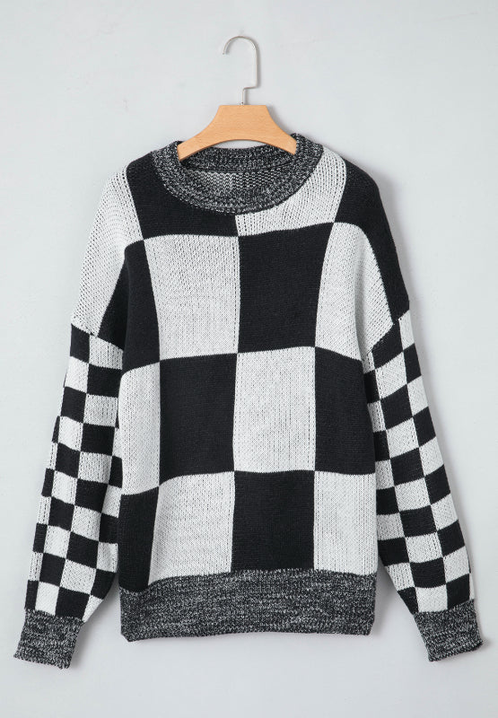Colorblock checkerboard knit sweater in black and white with a crew neck.