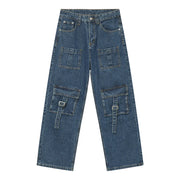 Medium wash denim cargo pants with buckle flap pockets and utility straps.