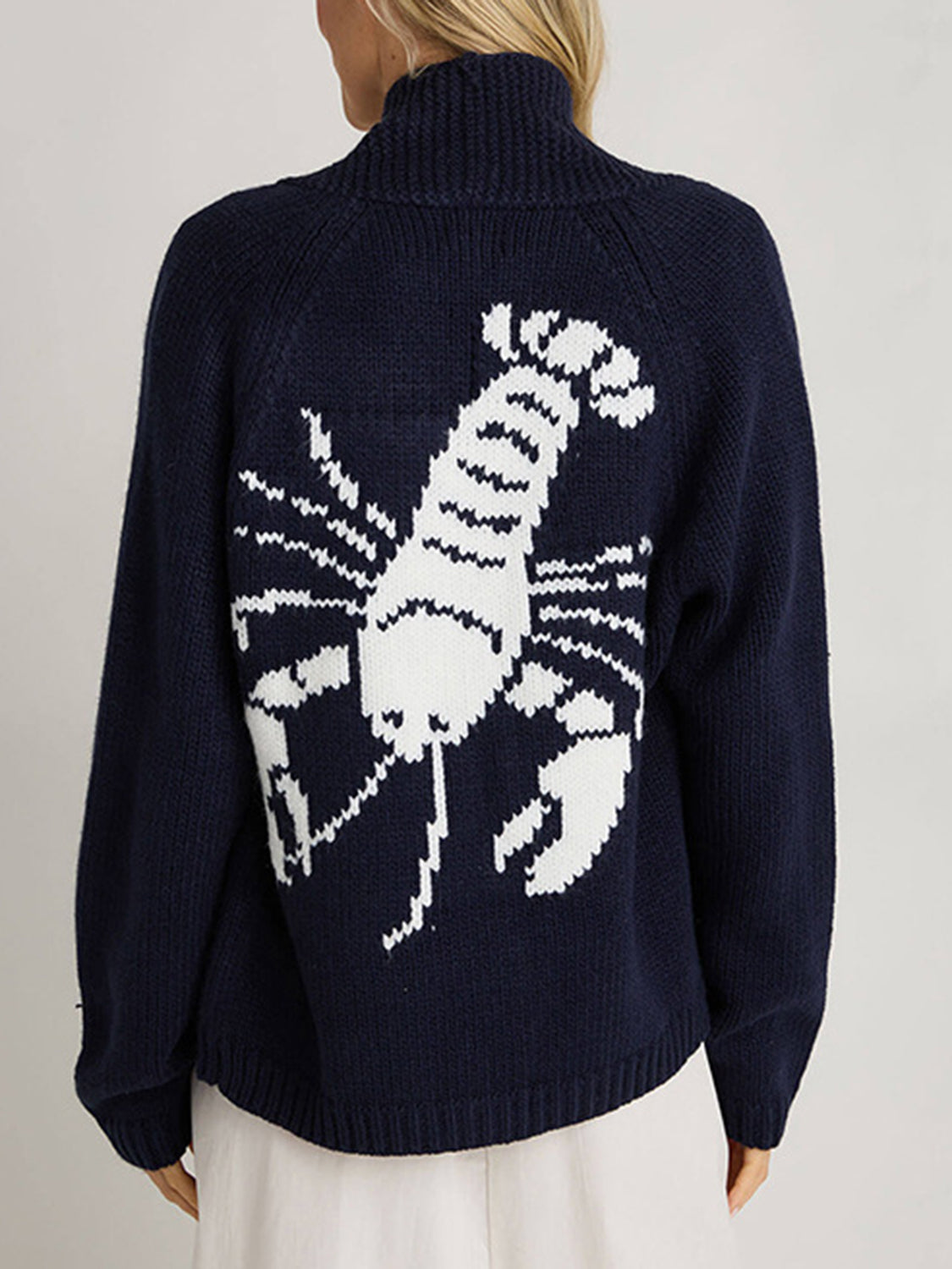 Dark blue acrylic knit cardigan with white lobster appliqué on back, turtleneck.