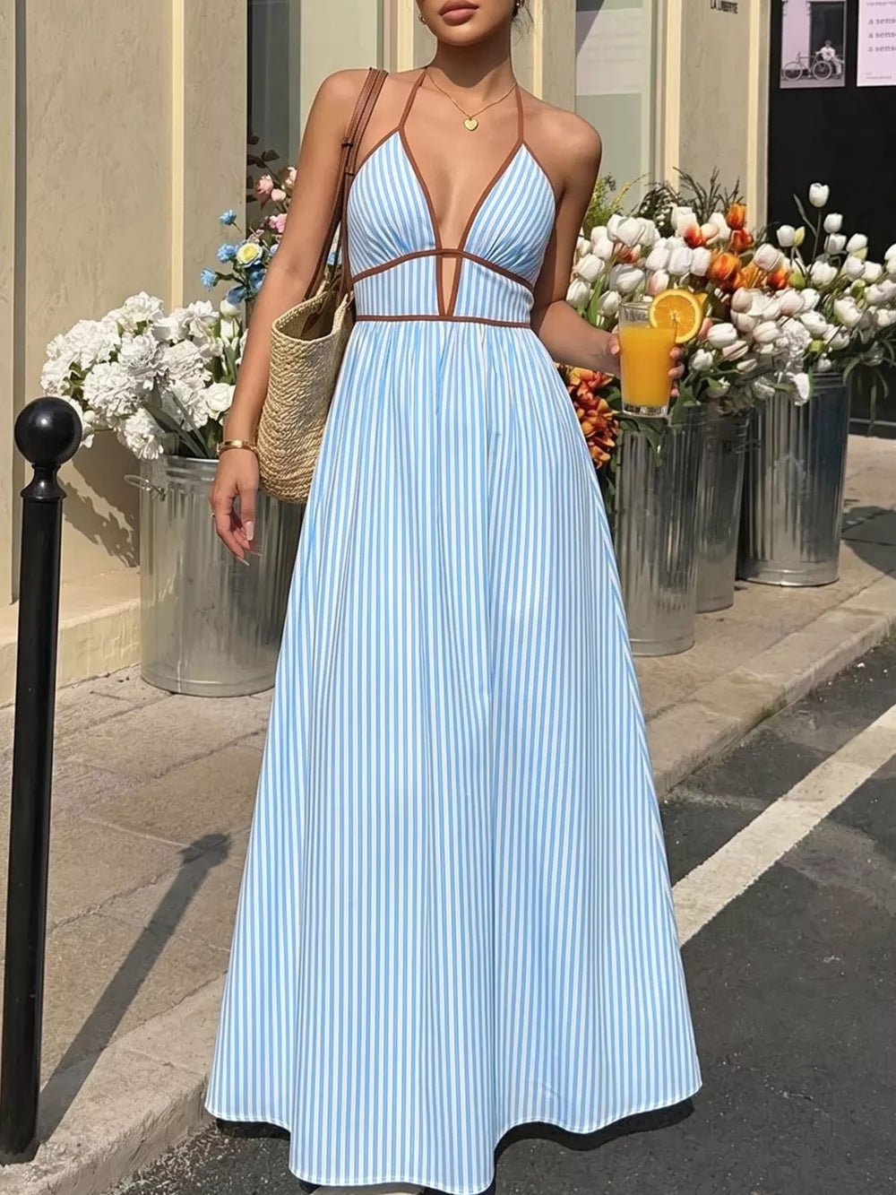 Blue striped halter maxi dress with plunging neckline and brown trim.