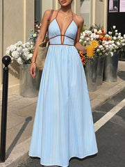 Blue striped halter maxi dress with plunging neckline and brown trim.