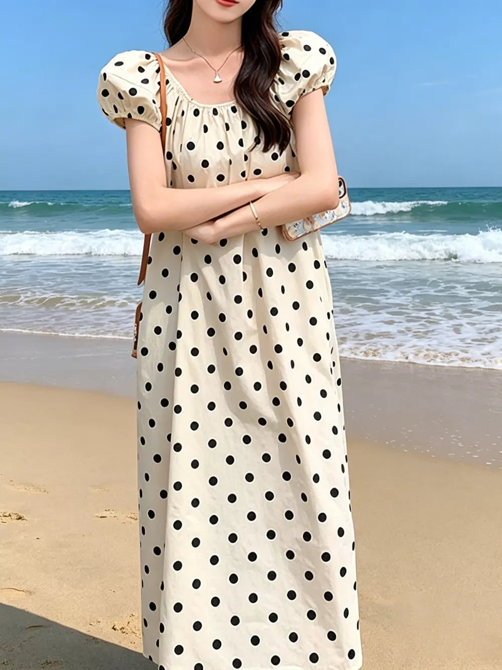Cream polka dot midi dress with puff sleeves and square neckline.