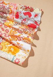 Patchwork sleeve t-shirt in beige with a floral print and ruffled hem detail.