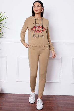 Khaki loungewear set with leopard print lips graphic and "Kiss me" text on hoodie.