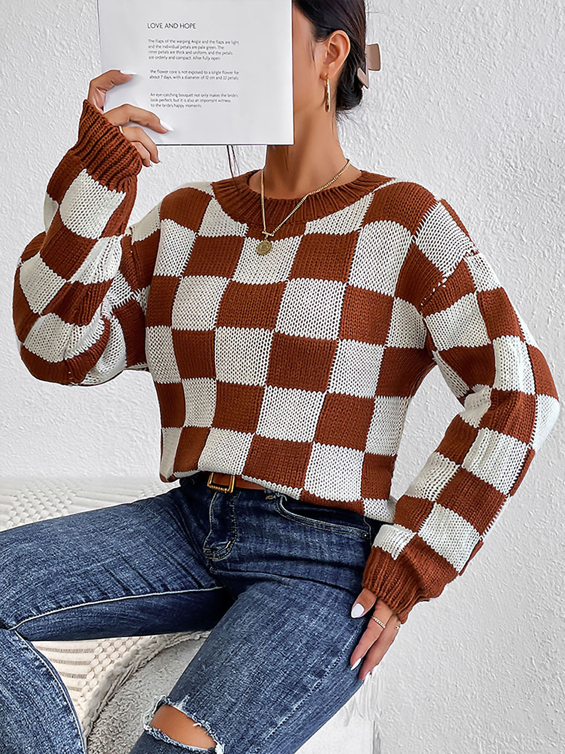 Checkerboard knit crewneck pullover sweater in chestnut and white acrylic with crew neck and long sleeves.