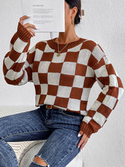 Checkerboard knit crewneck pullover sweater in chestnut and white acrylic with crew neck and long sleeves.