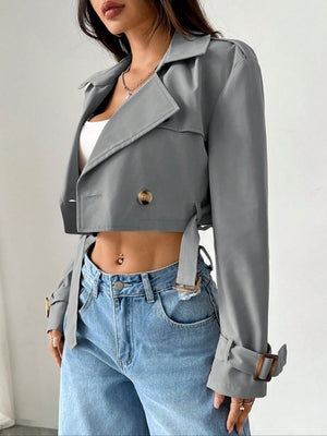 Chic cropped double-breasted trench coat in gray with belted waist and adjustable cuffs.