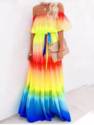 Off-shoulder tiered maxi dress with rainbow gradient, ruffle sleeves, and tie waist.
