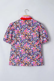 Floral print polyester shirt with red collar and plaid trim, puff sleeves.