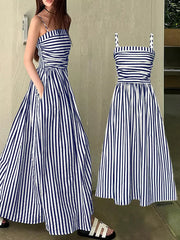 Navy blue and white striped maxi dress with spaghetti straps, cinched waist, and pockets.