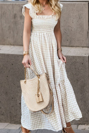 Smocked gingham maxi dress with flutter sleeves and square neckline.