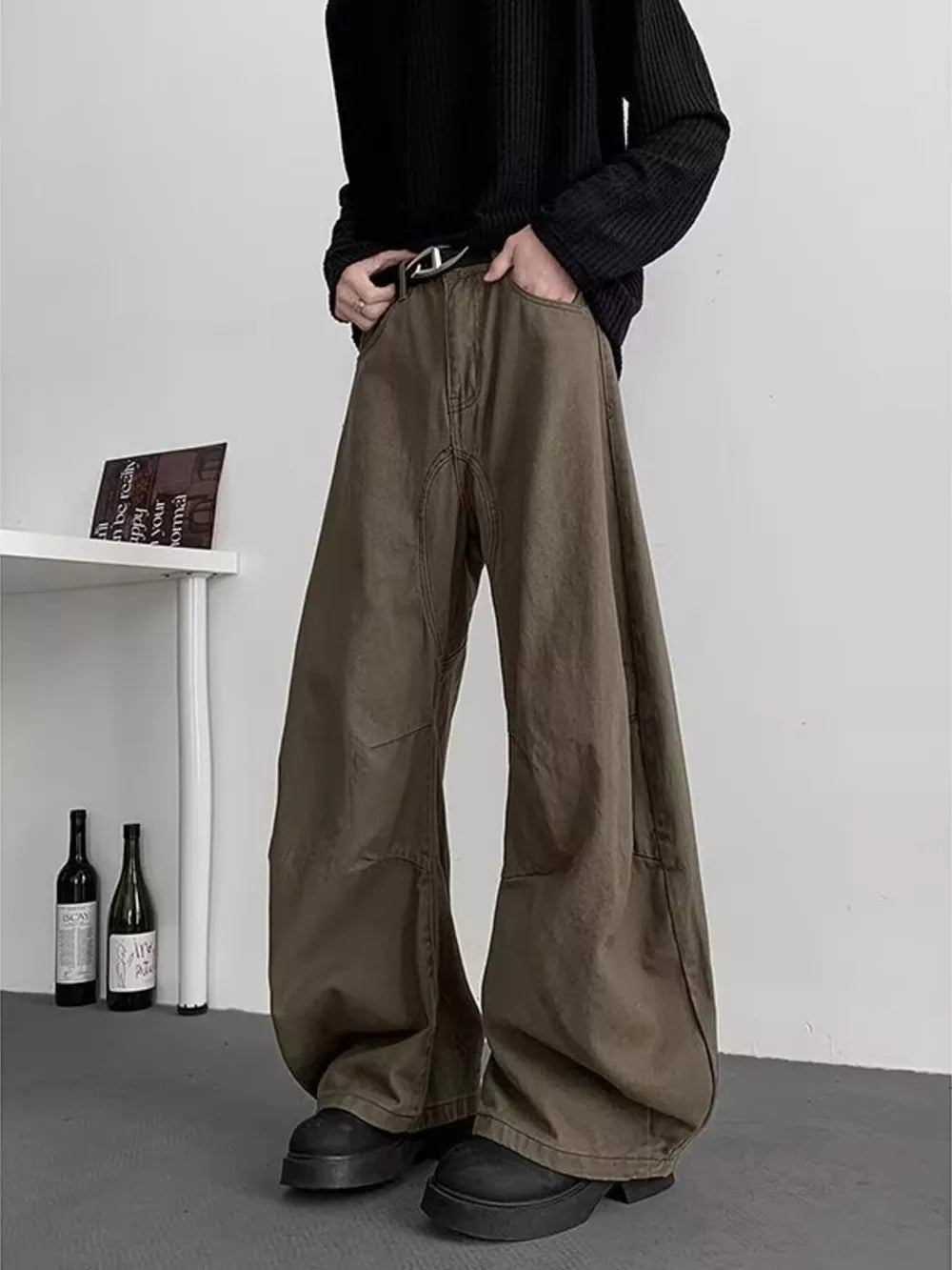Earthy brown oversized men's sweatpants with pockets and a belt.