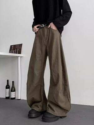 Earthy brown oversized men's sweatpants with pockets and a belt.