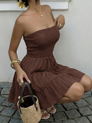 Gathered bodice tiered ruffle mini dress in dark brown, strapless, casual style.