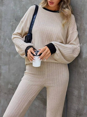 Tan ribbed knit lounge set with black trim details and bootcut pants.