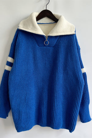 Royal blue ribbed knit quarter-zip sweater with white collar and sleeve stripes.