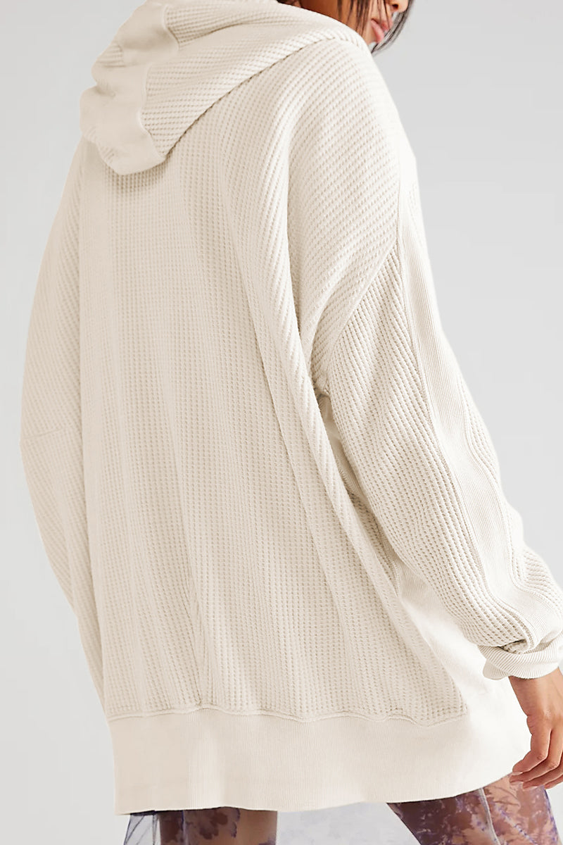 Beige waffle knit zip-through hoodie with a relaxed fit and dropped shoulders.