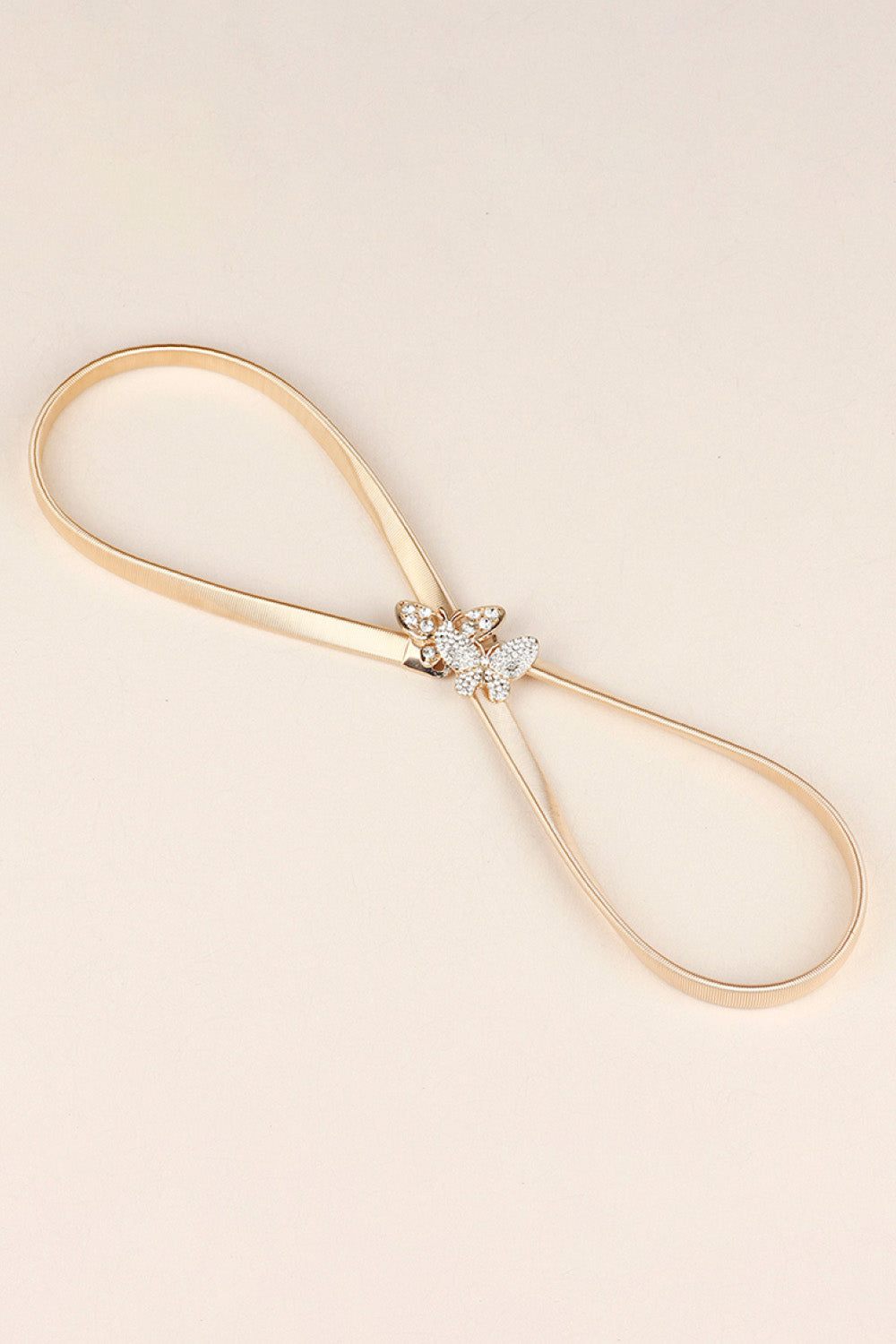 Gold metal belt with a crystal butterfly clasp detail