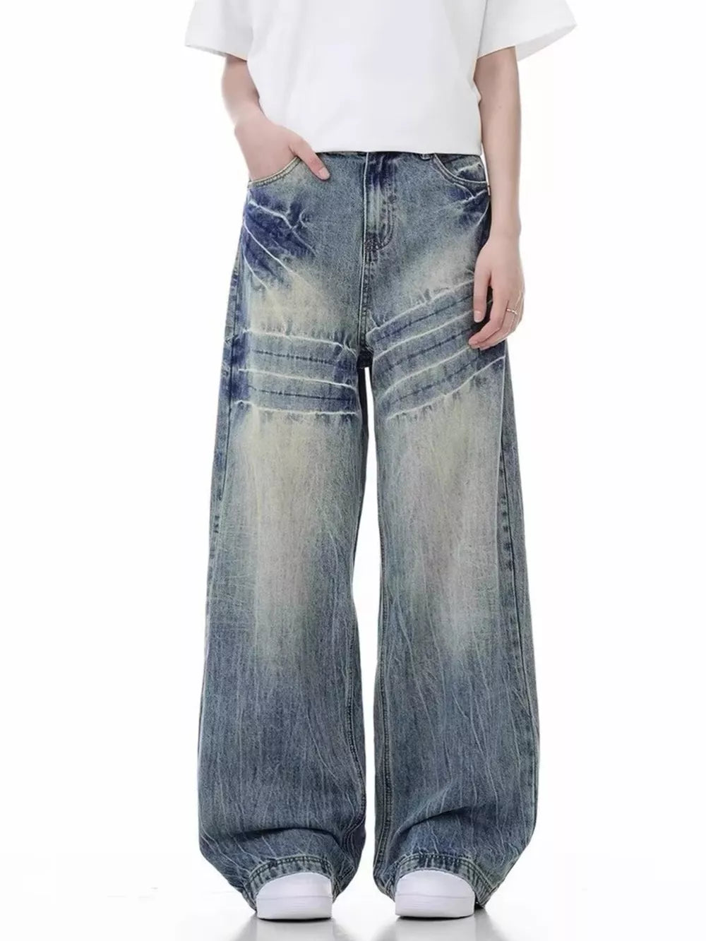 Distressed vintage wide-leg men's jeans in blue denim with a faded wash and whiskering details.