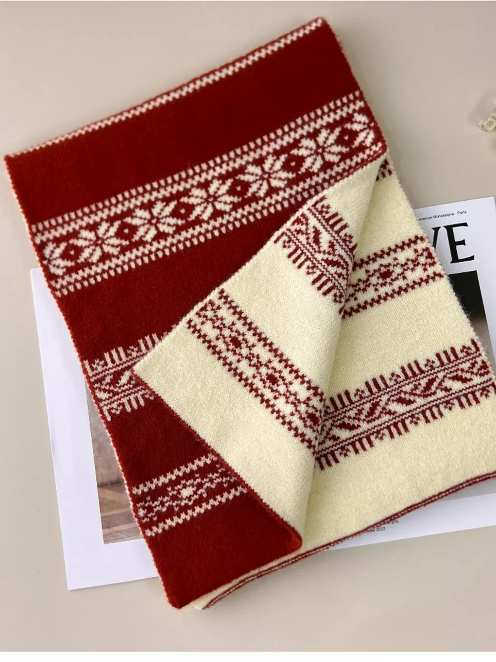 Reversible wool blend scarf in red with white snowflake pattern and cream with red pattern.