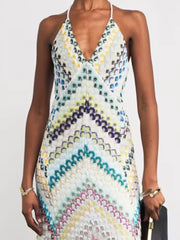 Chevron knit maxi dress with crisscross halter neckline and colorful pattern.