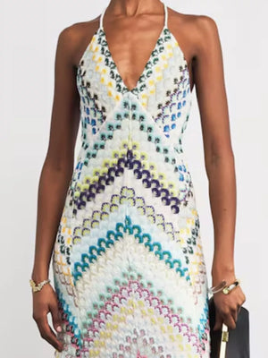 Chevron knit maxi dress with crisscross halter neckline and colorful pattern.
