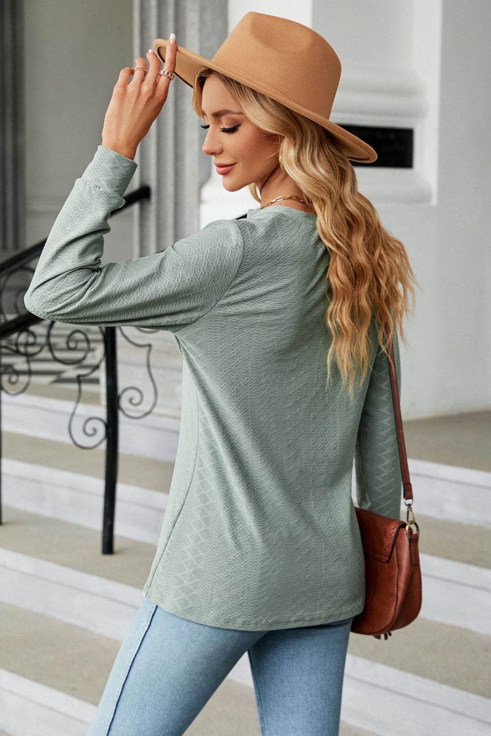 Sage textured henley blouse with button detail and long sleeves.