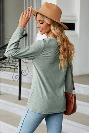 Sage textured henley blouse with button detail and long sleeves.