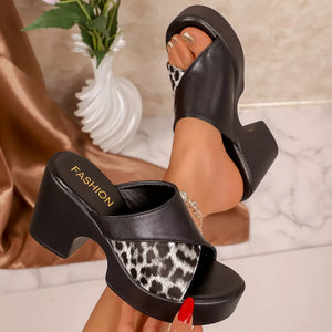 Black platform sandals with leopard print detail and block heel.
