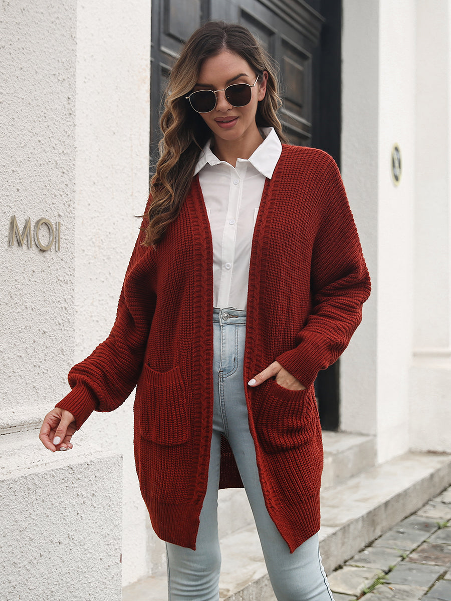 Burgundy ribbed knit cocoon cardigan with pockets and balloon sleeves.