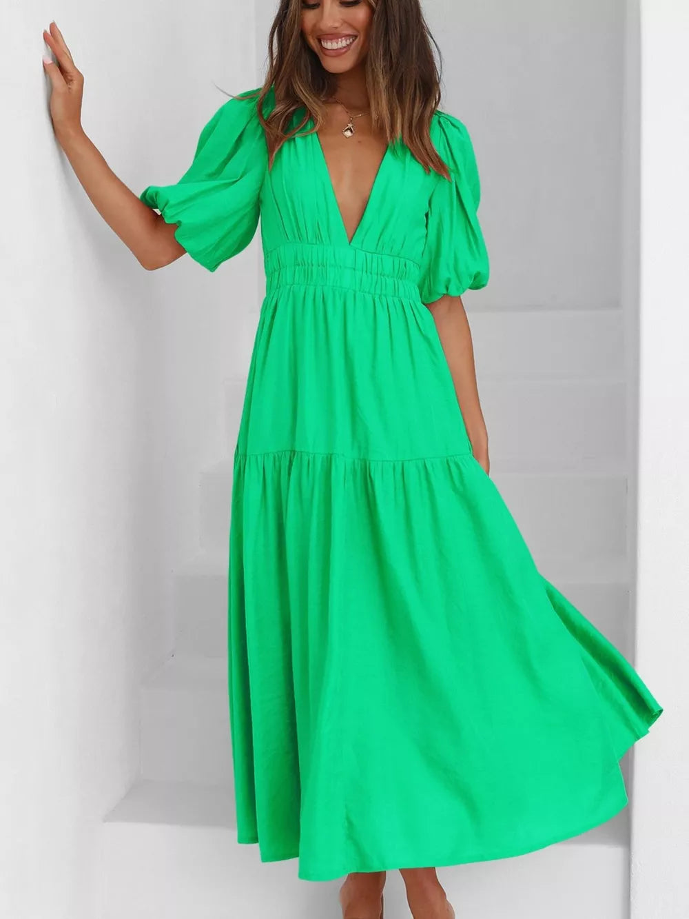 Green midi dress with V-neck, cinched waist, and puff sleeves.