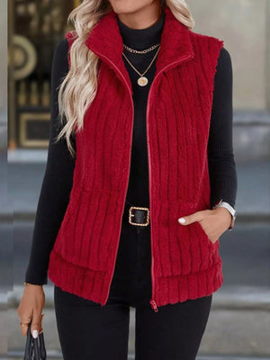 Red fleece zip-up vest with pockets and a standing collar.