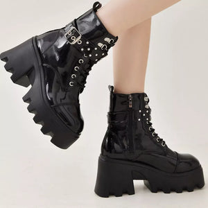 Black glossy platform ankle boots with buckle accents and chunky heel
