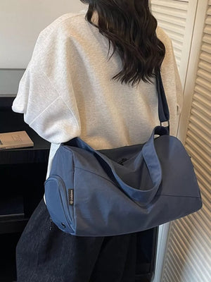 Blue Oxford cloth travel bag with adjustable strap and side pocket
