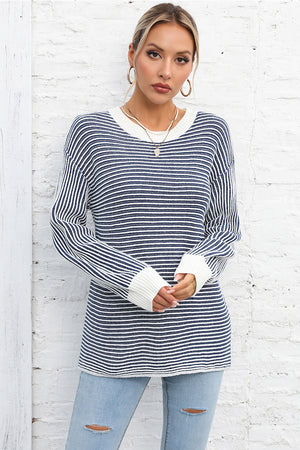 Nautical stripe ribbed knit crewneck sweater in navy and white with white cuffs.