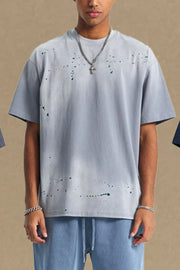 Gray oversized t-shirt with multicolor paint splatter detail and crew neck.
