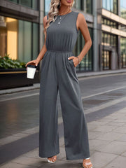 Sleeveless dark gray palazzo jumpsuit with gathered waist and pockets.