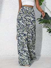 Palazzo trousers in navy with a tropical leaf print, made of 100% polyester.