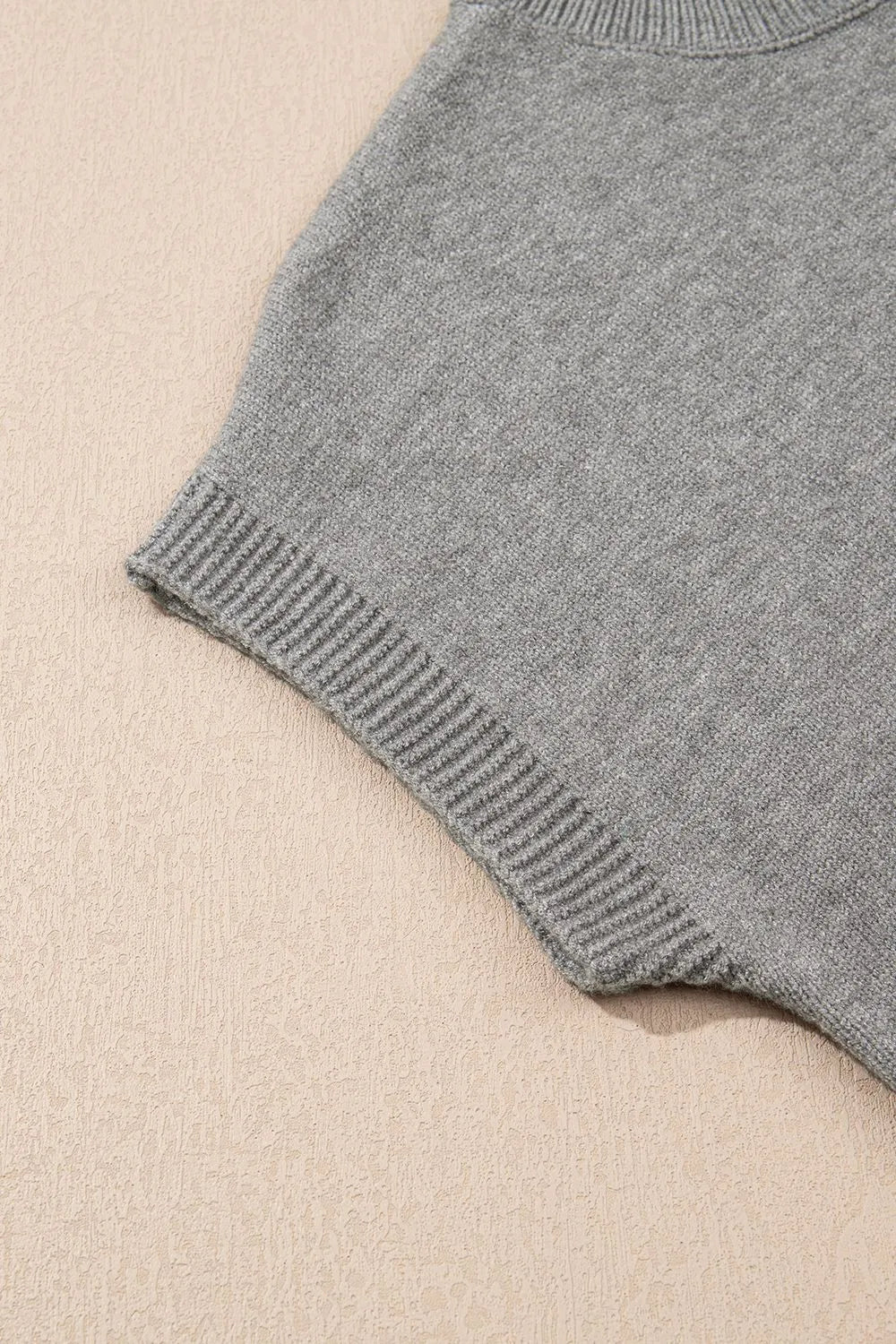 Gray knit top with ribbed hem detail