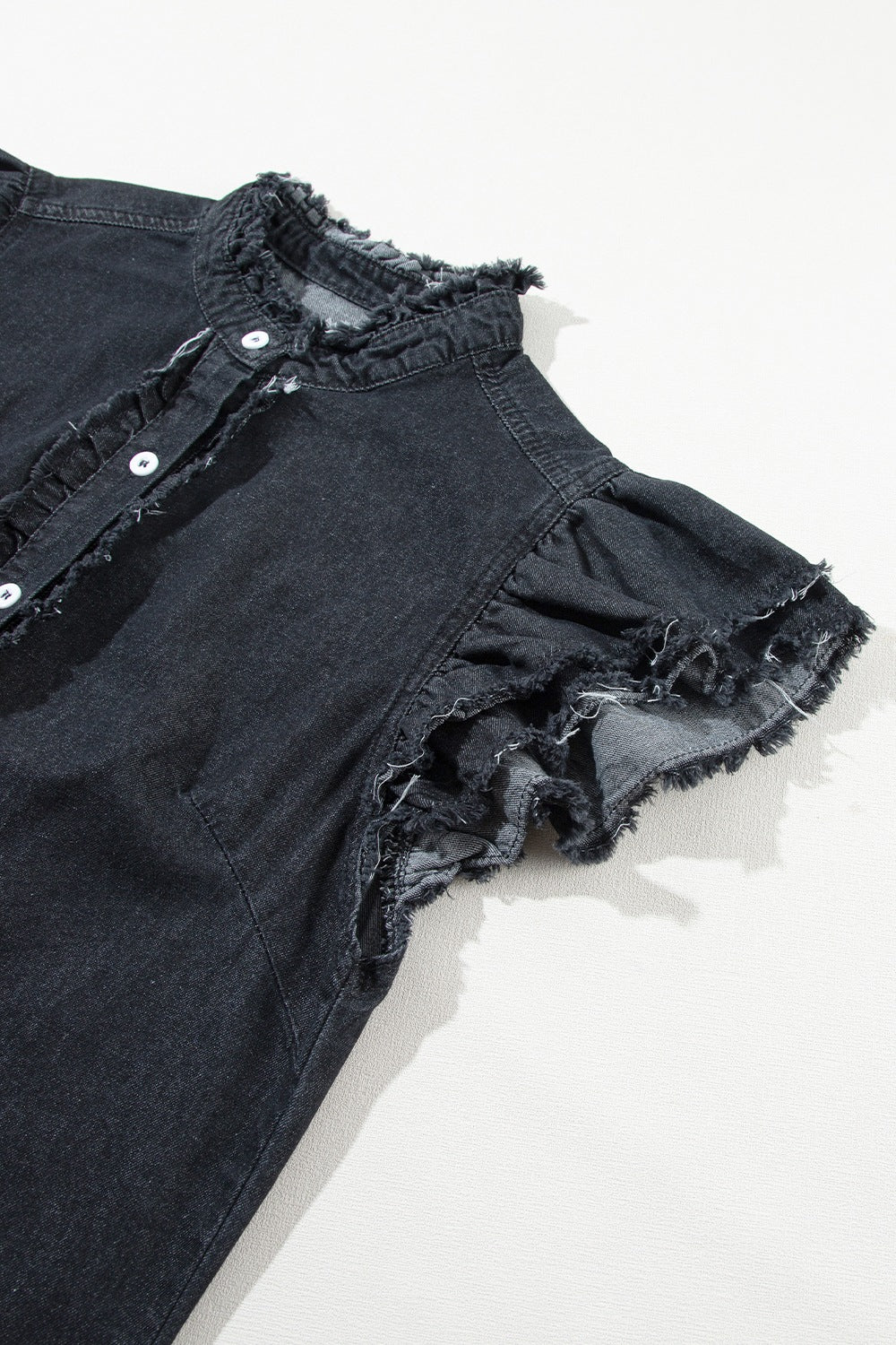Black denim button-up shirt with frayed ruffle trim on collar and sleeves