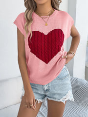 Blush pink cable knit sweater vest with a large red cable knit heart graphic.