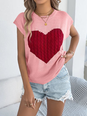 Blush pink cable knit sweater vest with a large red cable knit heart graphic.